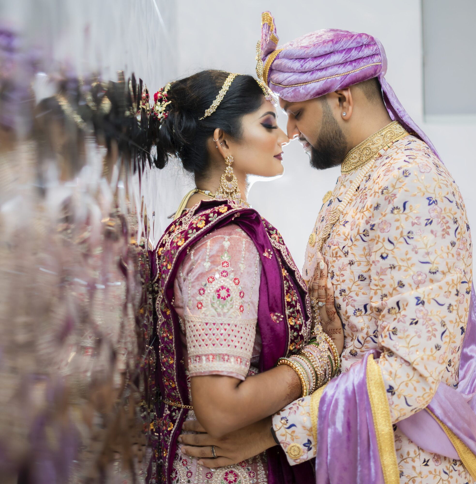 Newlyweds sharing an intimate wedding-day portrait in traditional dress