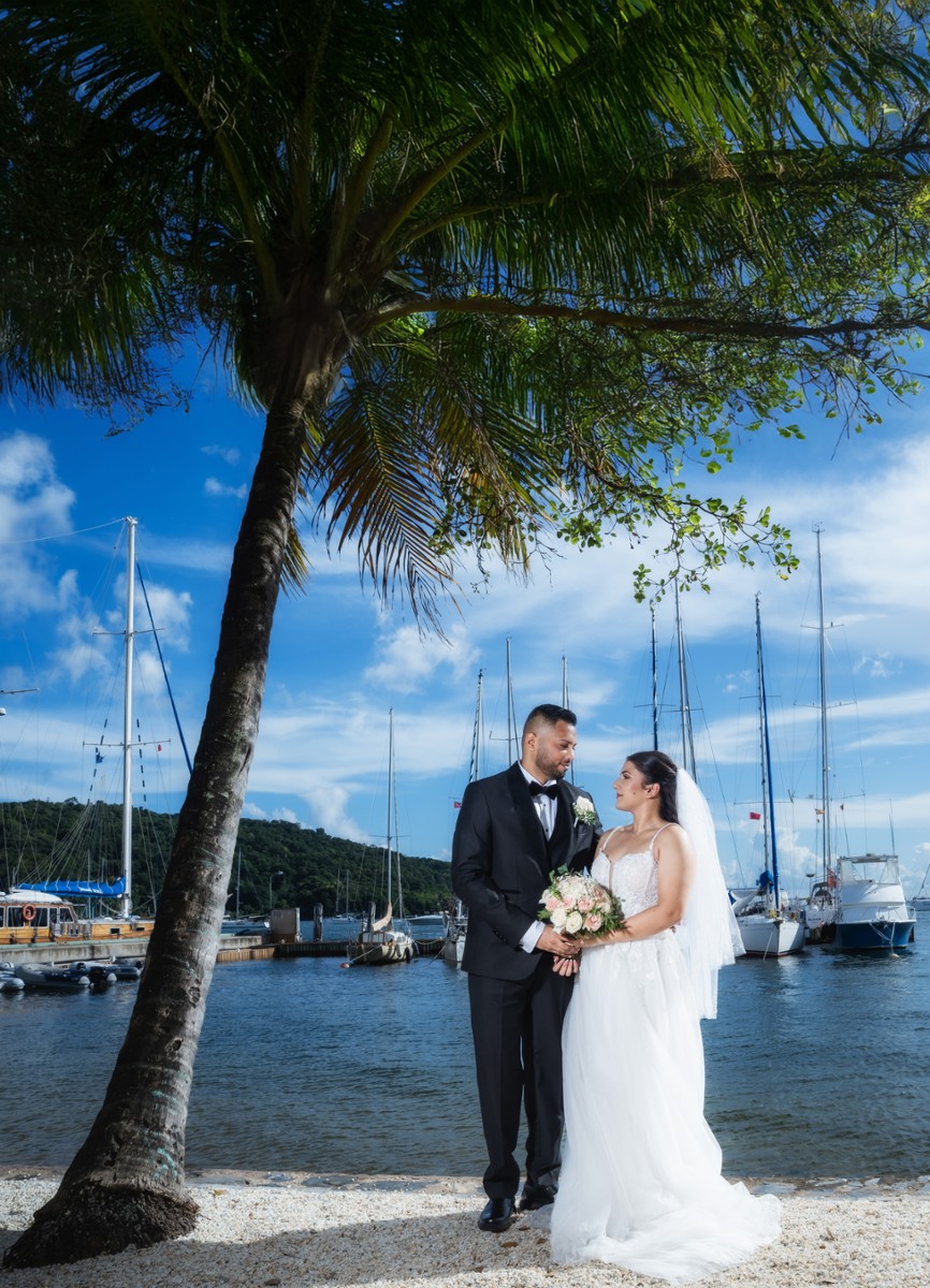 Newlyweds sharing a quiet look beside the marina